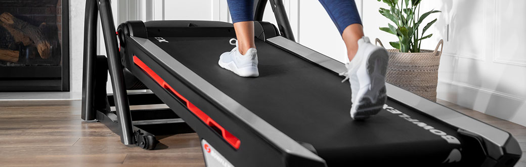 A person walking on a BowFlex treadmill.