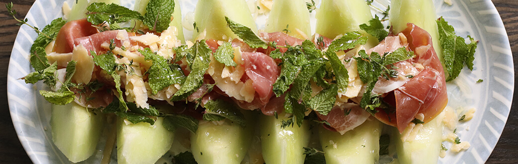 Prosciutto, Parmesan, and Honeydew appetizer on a serving dish.