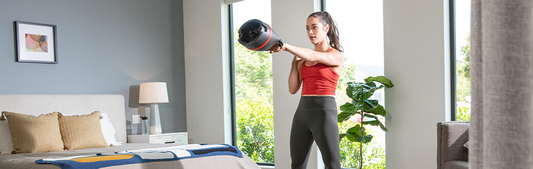 A woman performing a kettlebell workout.