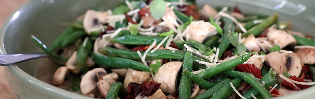 Green beans, mushrooms, bacon, and other ingredients in a bowl.