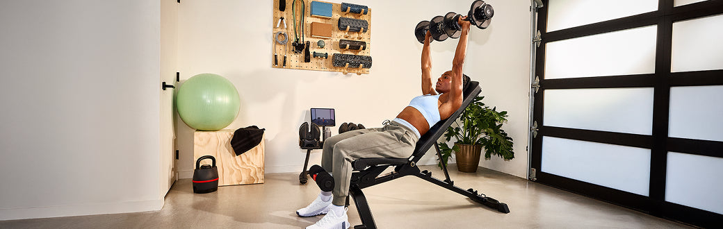 A woman doing a dumbbell workout
