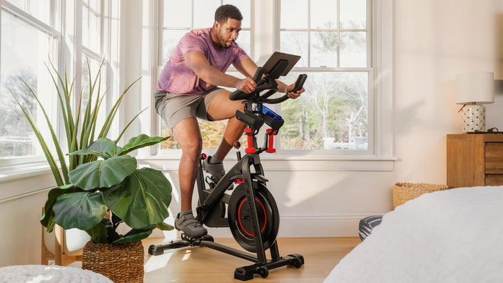Man riding a stationary BowFlex C6 exercise bike