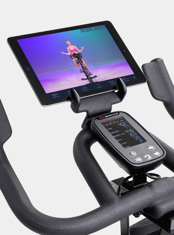 BowFlex C6 Bike media rack holding a tablet displaying JRNY app screen.