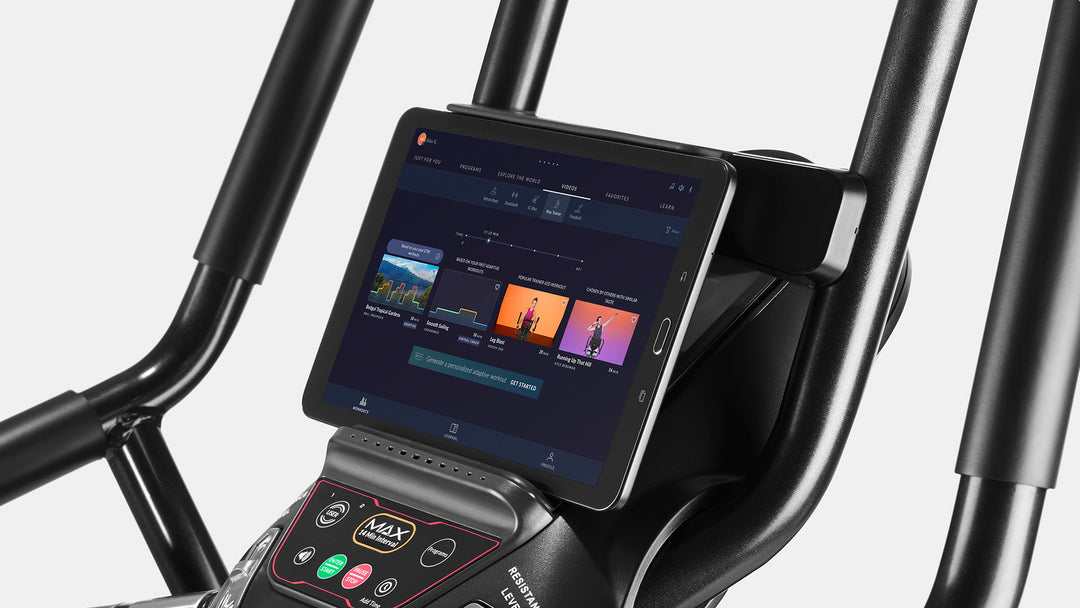 Close-up of a Max Trainer M6 console with a tablet on its media rack.