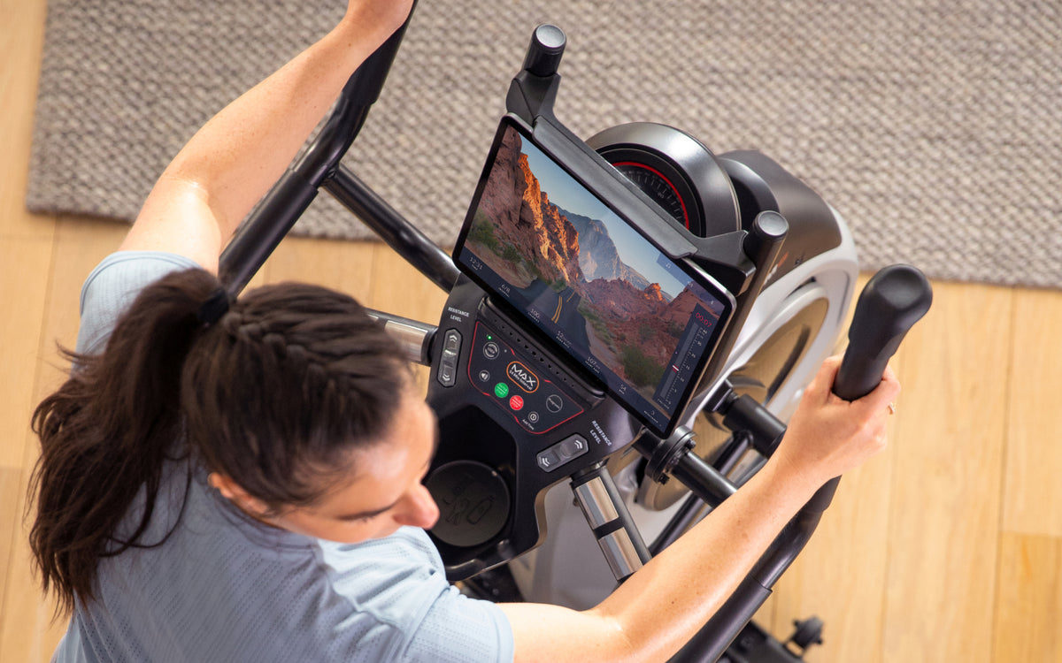 Woman using a BowFlex Max Trainer M6 with the JRNY fitness app