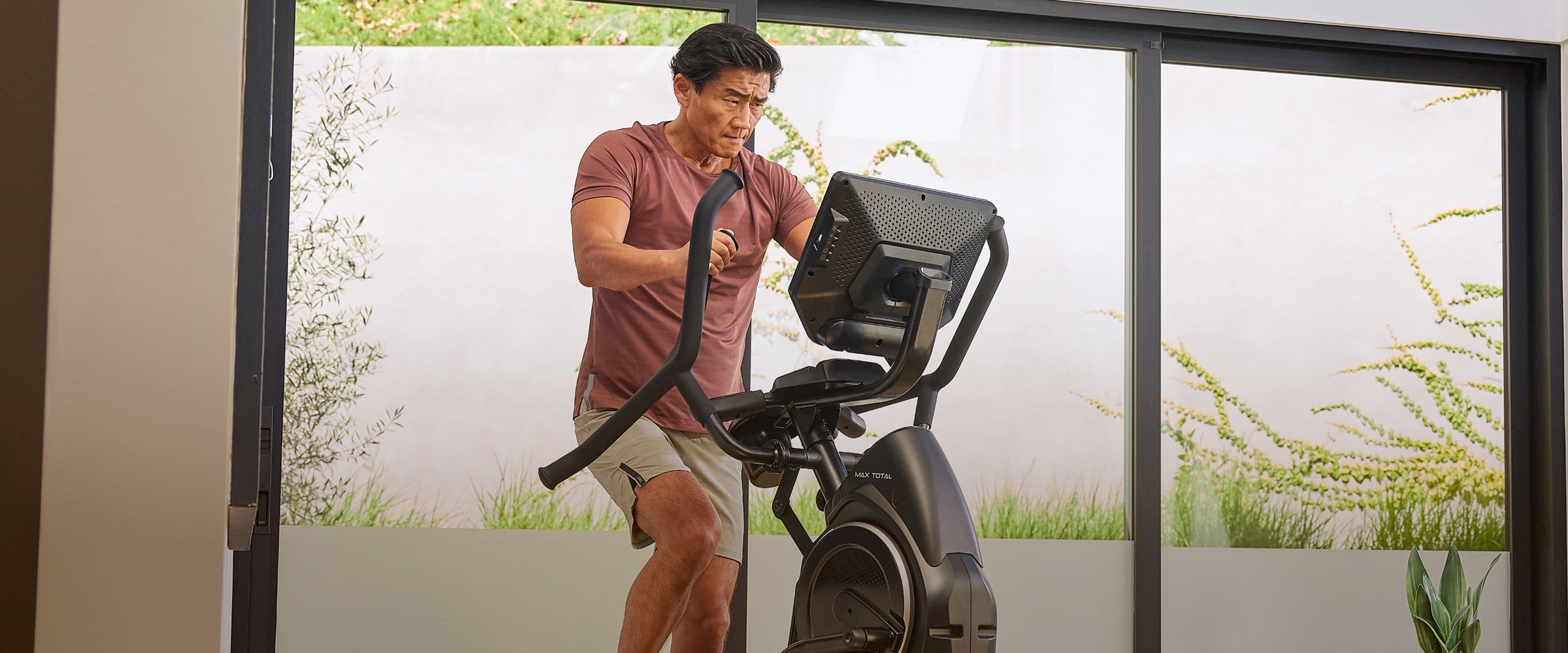 Man on a Max Trainer Max Total 16 cardio machine