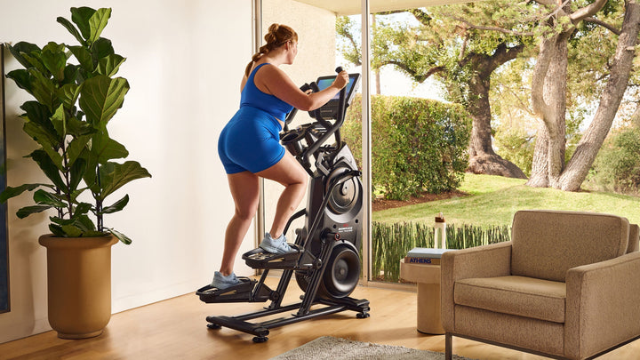 Woman exercising on a BowFlex Max Total 16.
