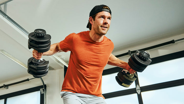 Man doing a chest fly with the BowFlex Results Series 52 Dumbbells