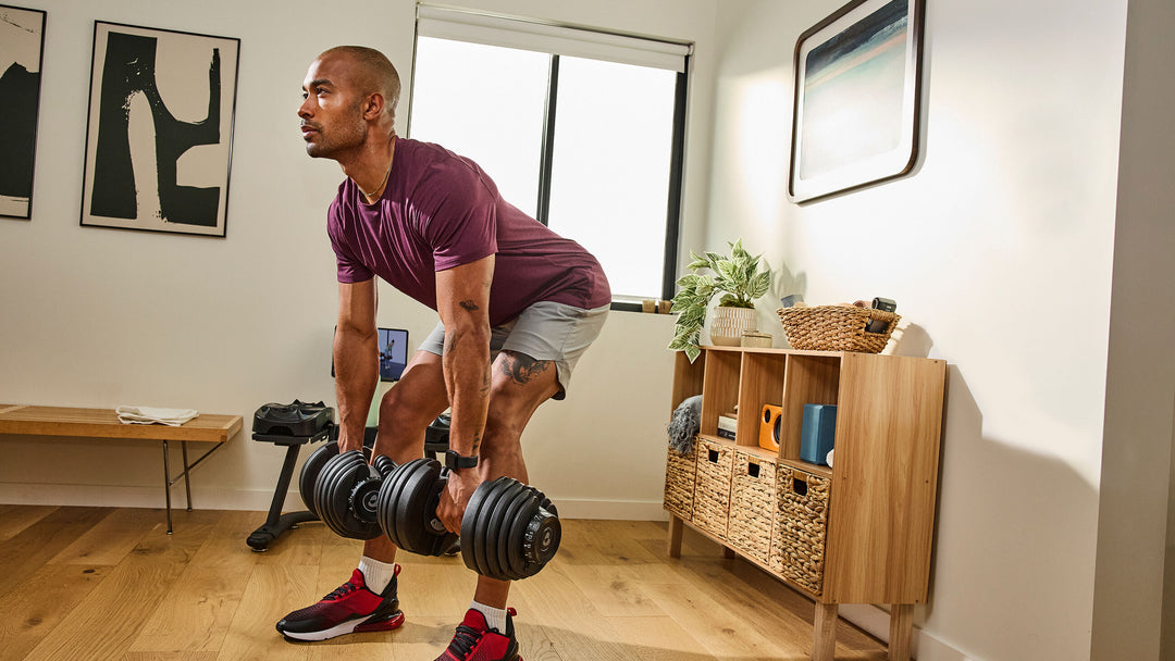Man exercising with a pair of Results Series 552 dumbbell