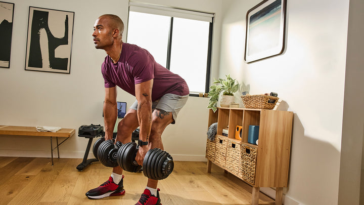 Man exercising with a pair of Results Series 552 dumbbell