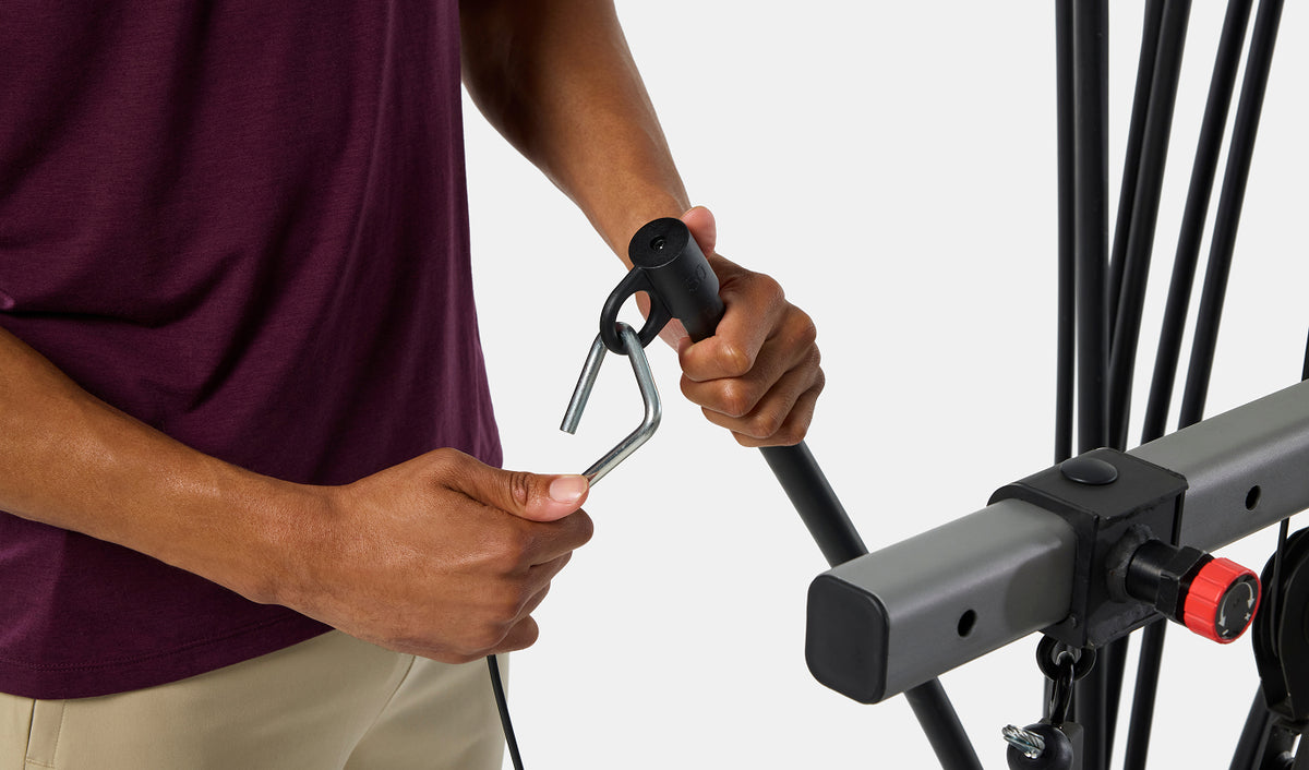 Hands adjusting the Power Rod® resistance weight on the BowFlex 
Xtreme 2 SE Home Gym.