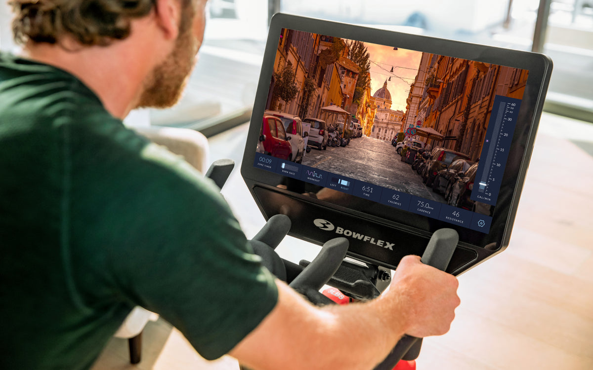 Man using a BowFlex VeloCore Bike with the JRNY fitness app