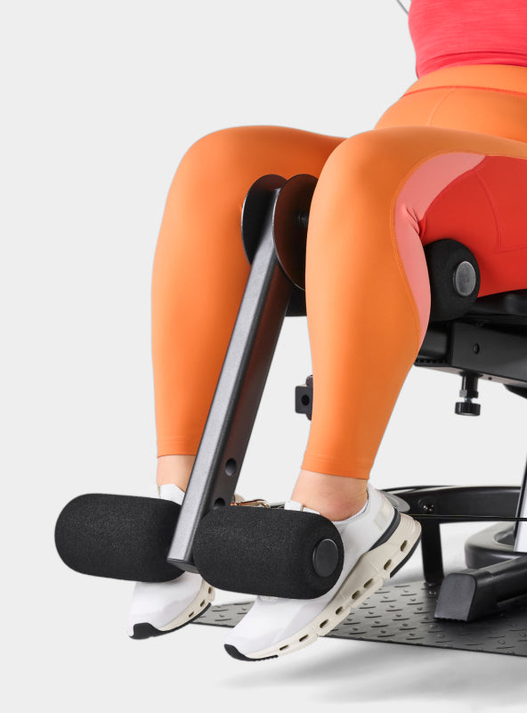 Person using the BowFlex Xtreme 2 SE leg extension attachment.