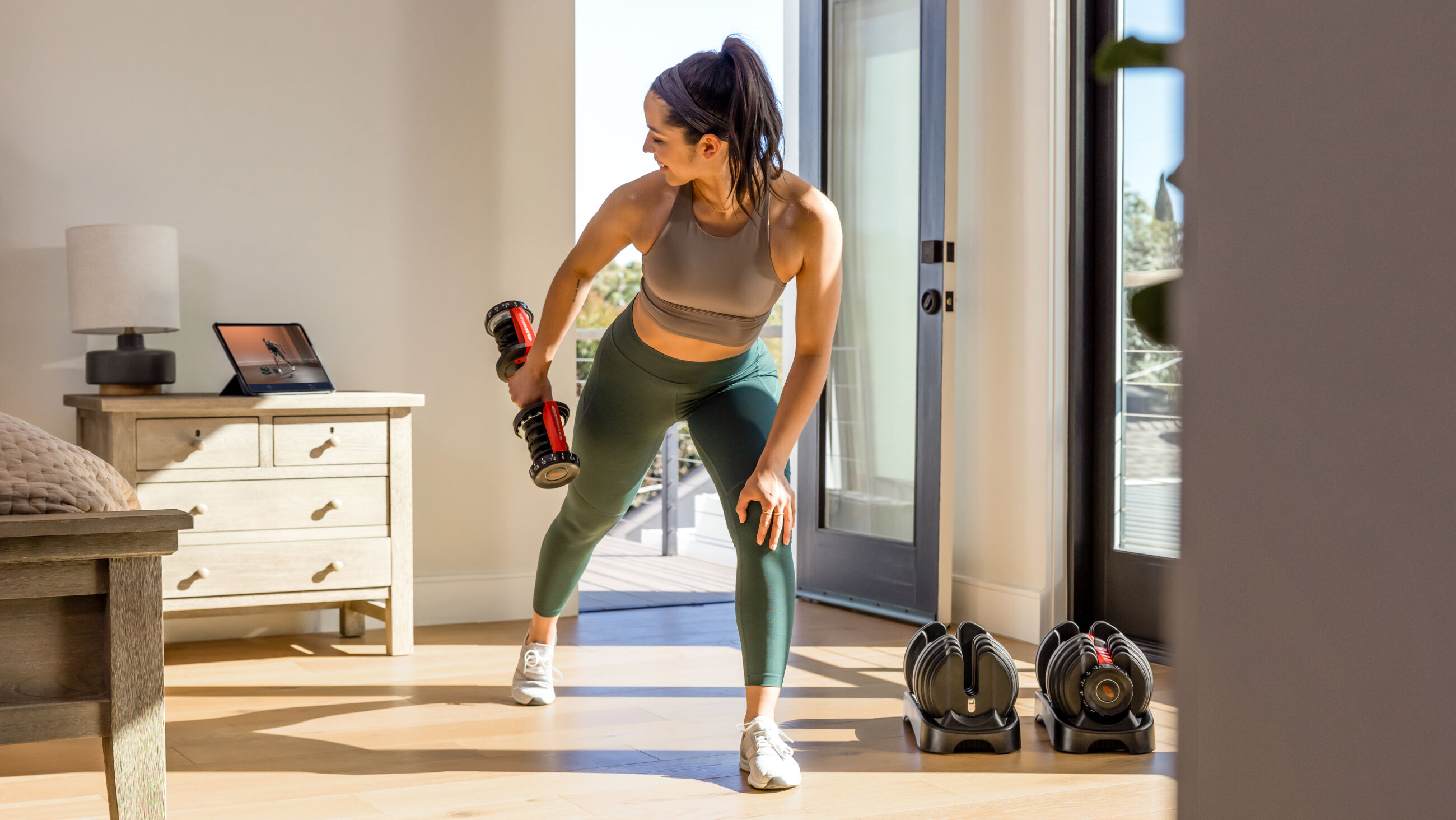 Woman performing triceps kickbacks with 552 dumbbells - default view