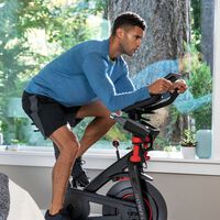 Man riding a stationary Bowflex C6 exercise bike--thumbnail