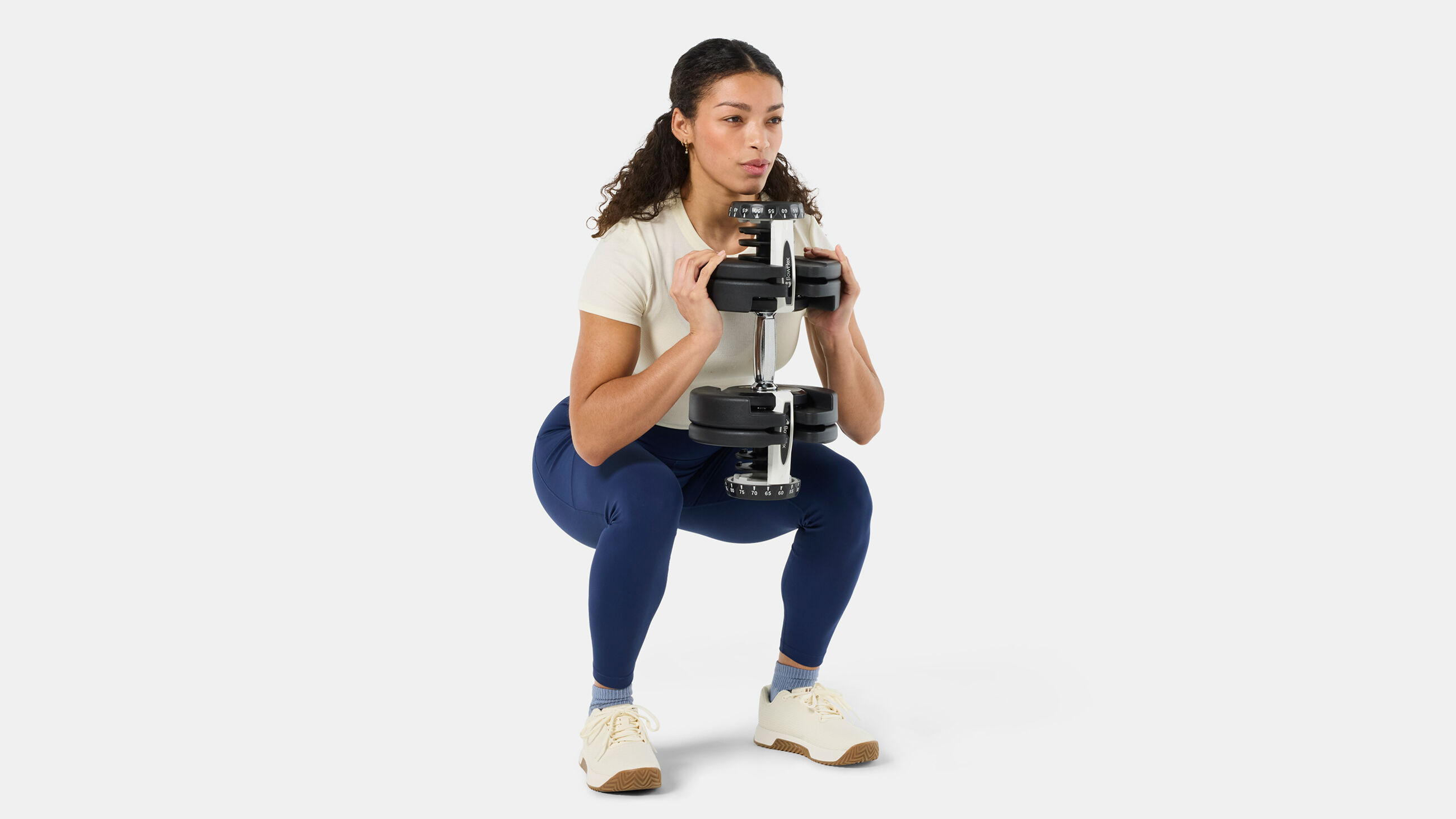 BowFlex Results Series 90 SelectTech Dumbbells - woman doing a squat with dumbbell - default view