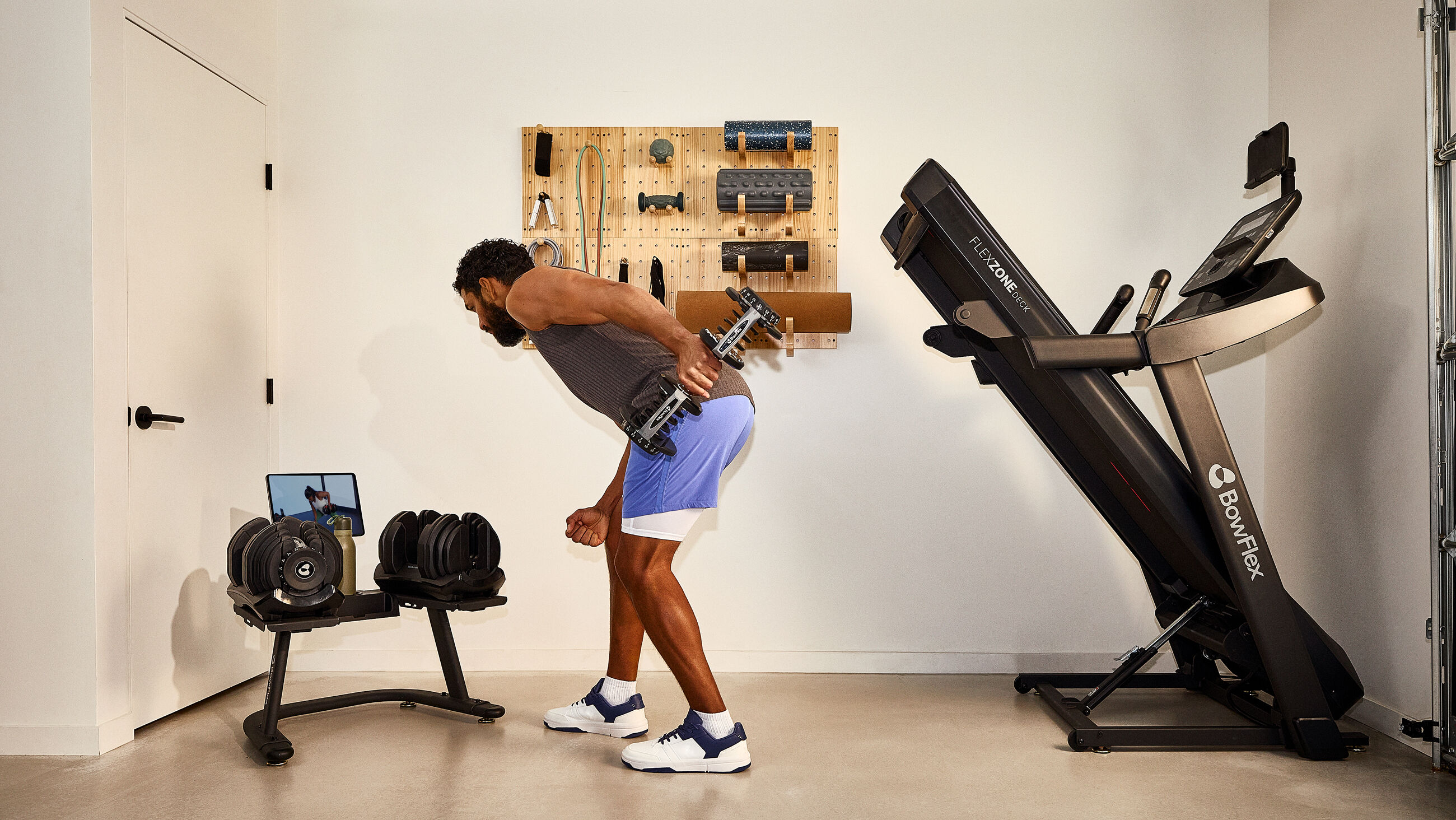 Man exercising with a single Results Series 1090 dumbbell - default view