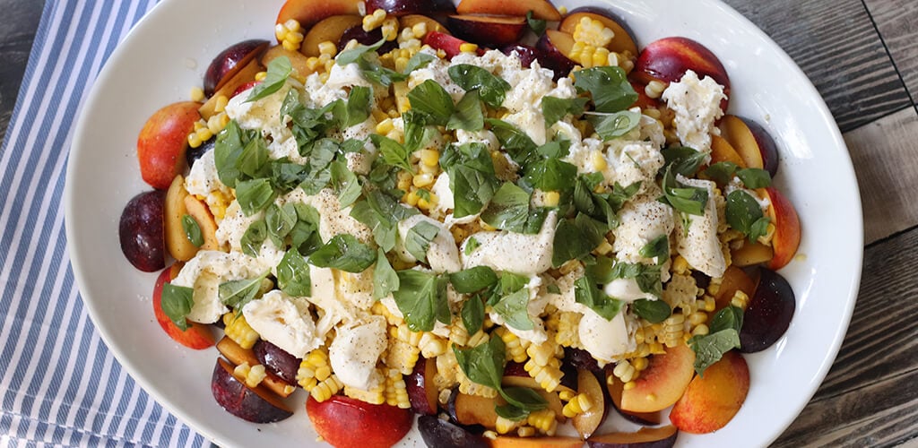 Stone fruit salad in a serving bowl.