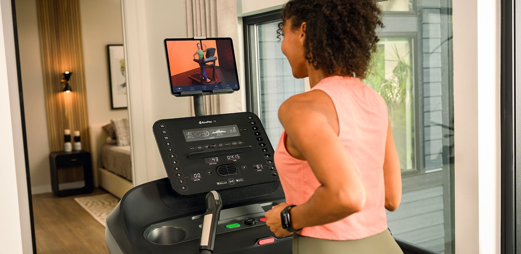 woman looking at a bowflex treadmill screen