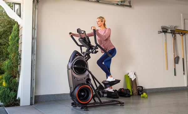 A fit woman using a BowFlex Max Trainer