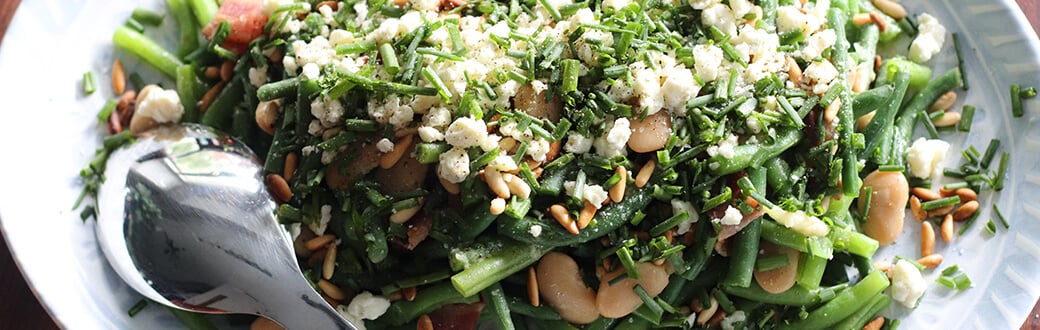 Blue and green bean salad in a serving dish.
