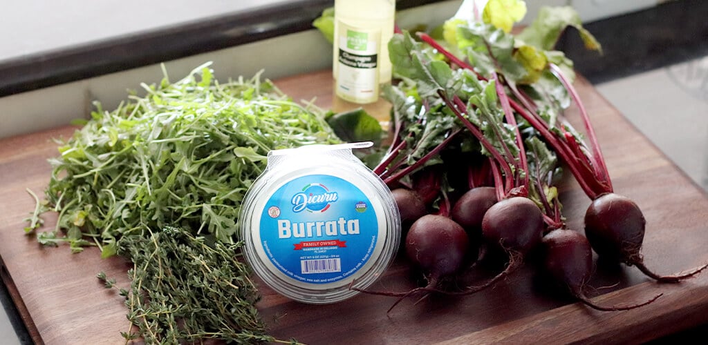 Burrata and beets on a cutting board