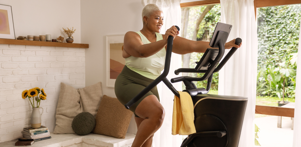 Woman in a home using a Max Trainer.