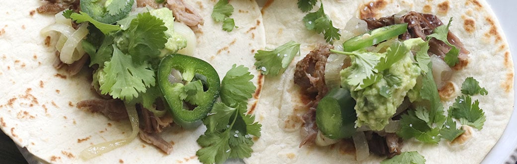 Pork carnitas on tortillas.