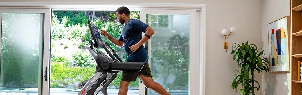 Man running on a Bowflex treadmill