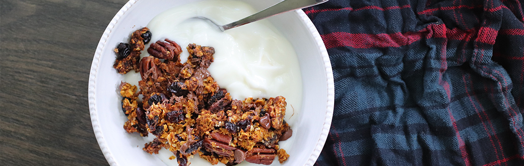 homemade pumpkin pecan granola sprinkled over vanilla yogurt