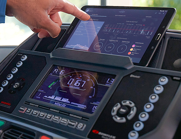 man using JRNY App to see his treadmill workout achievements