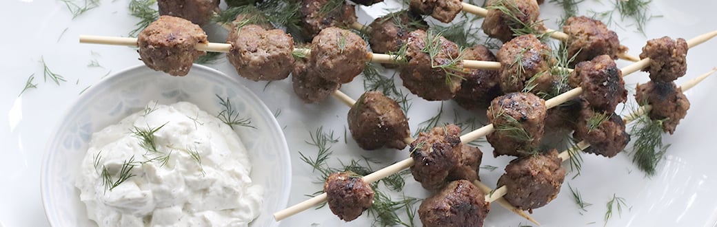Lamb meatball skewers served with dipping sauce