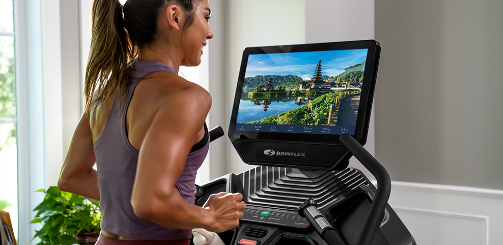 A woman using Bowflex JRNY on a Bowflex Treadmill.