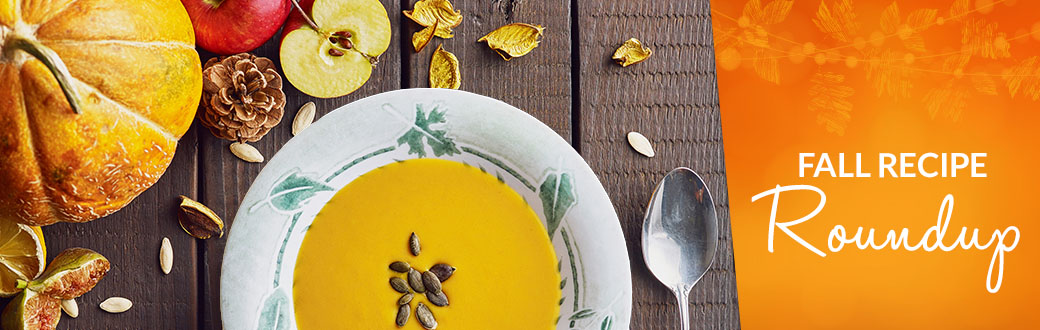 A bowl of pumpkin soup on a table.
