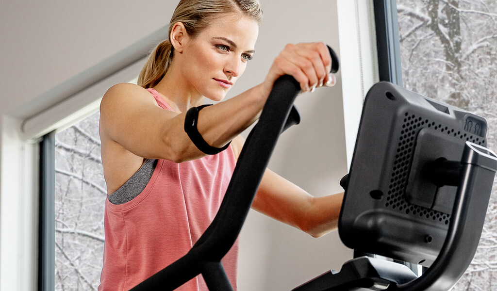 A fit woman using a max trainer.