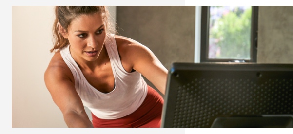 A woman using lean mode on a VeloCore Bike.