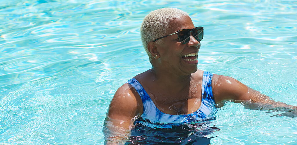 A woman smiling in a pool.