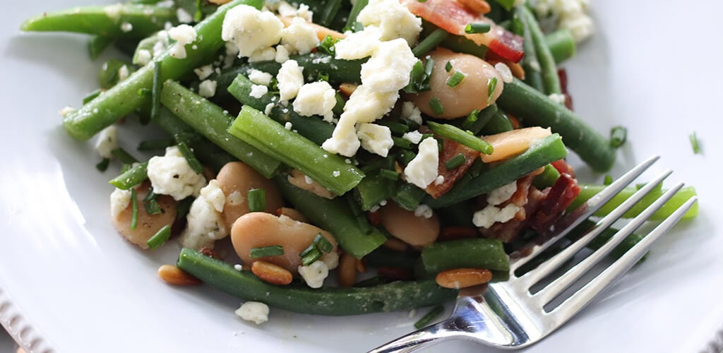 Blue and green bean salad in a serving dish.