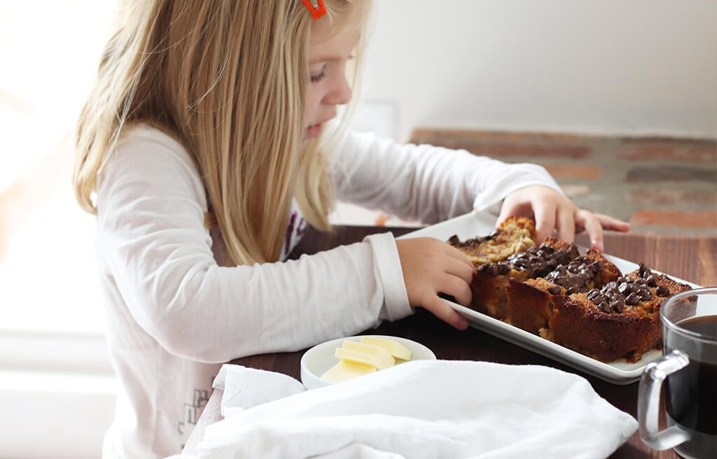 A child eating chocolate chip banana bread