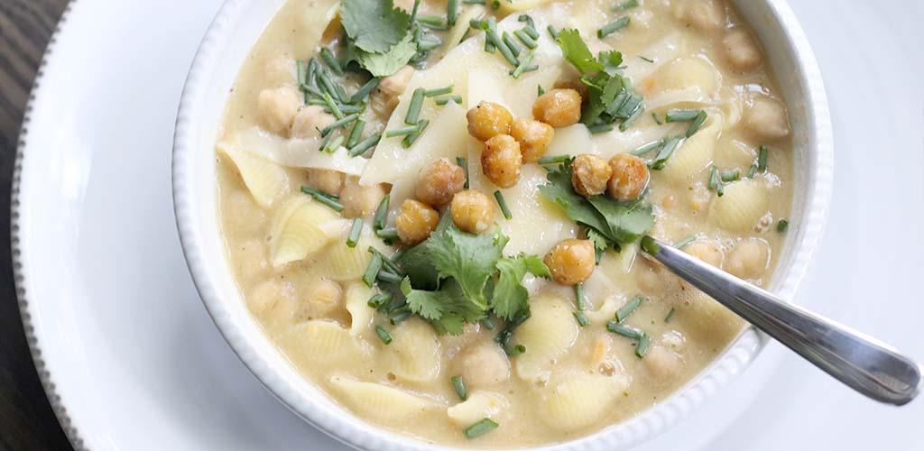 Chickpea noodle soup in a serving dish.