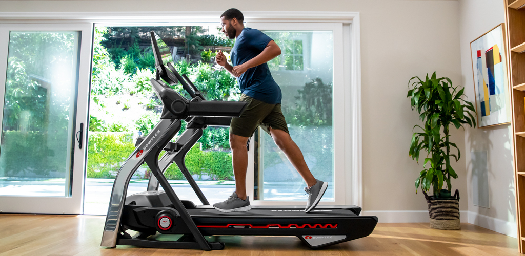 Man running on a BowFlex Treadmill in a living room