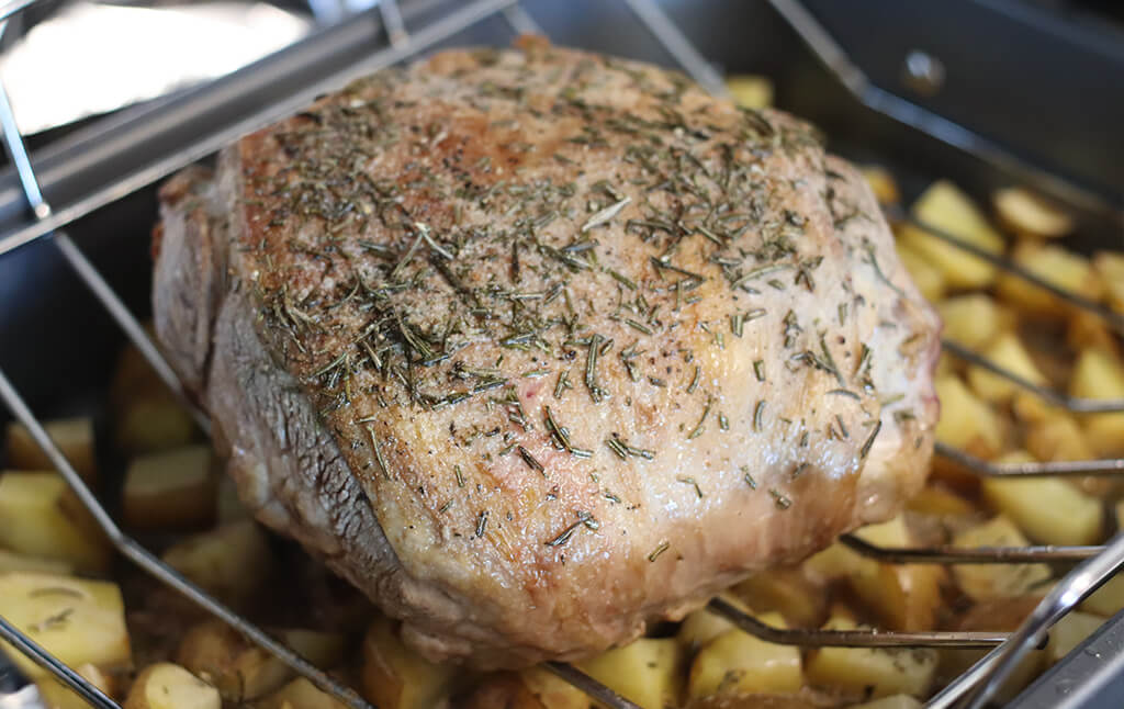 roasted lamb in a roasting pan