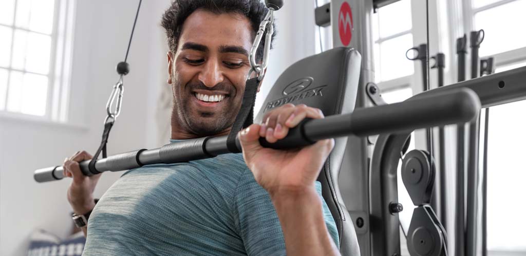 A man using a BowFlex X2SE Home Gym.