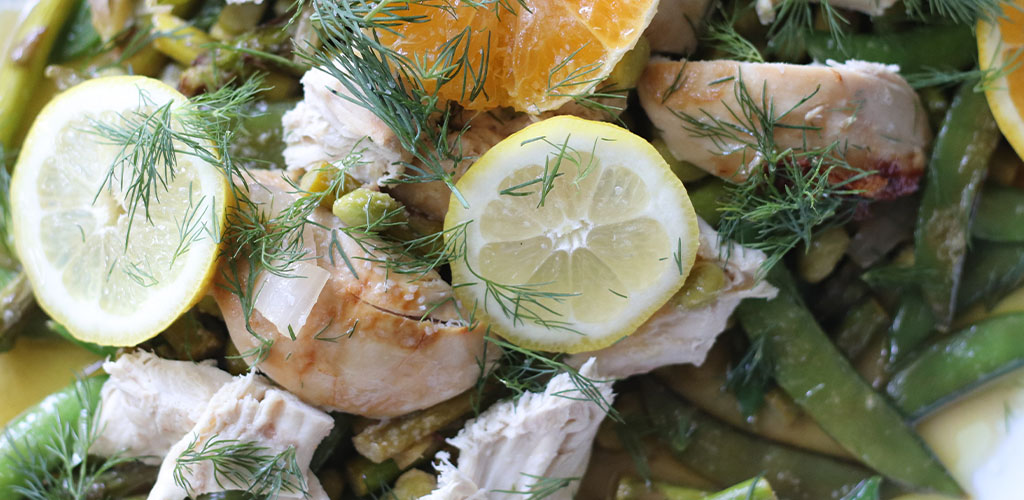 Lemon, arugula, and herb potatoes in a serving dish.