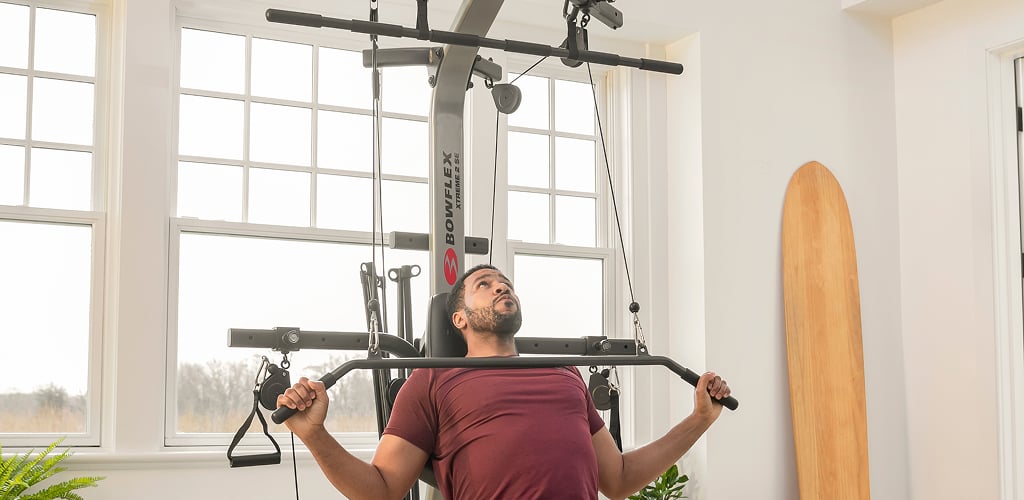 man using xtreme 2 se home gym
