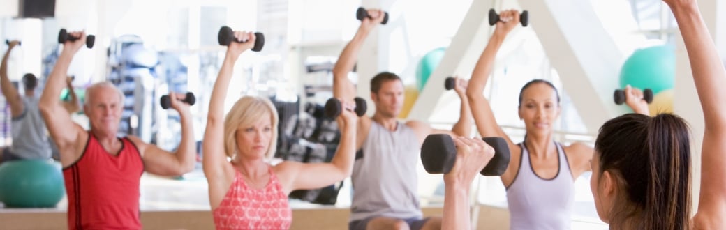 Resistance training class using free weights at the gym