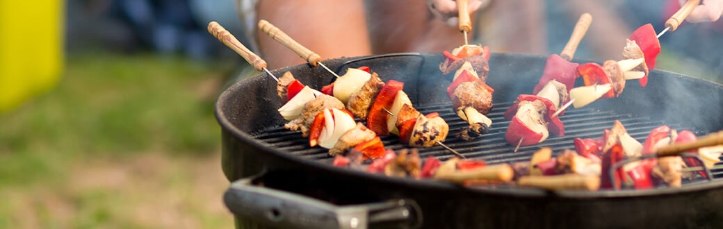 kabobs cooking on a grill.