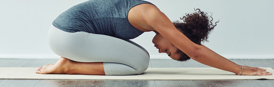 A woman performing a yoga stretch