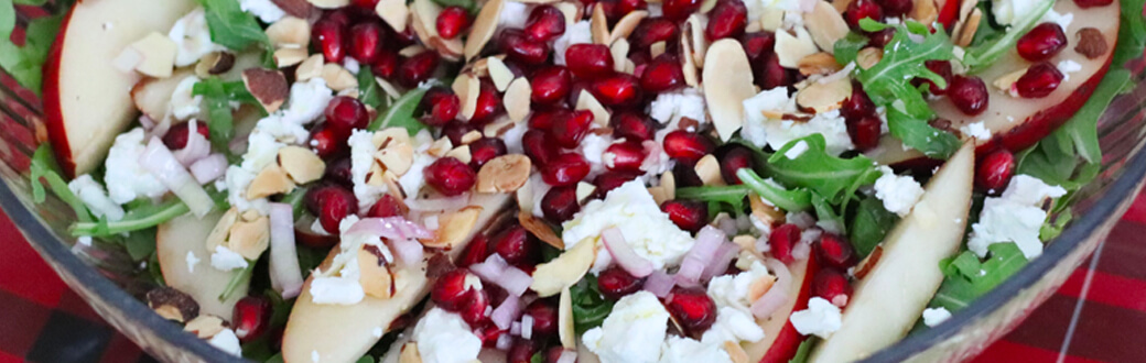 Pomegranate arugula salad in a bowl.