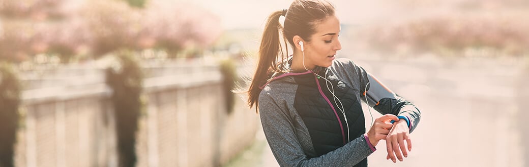 A woman using her fitness watch.